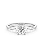     A 0.50 carat diamond four-prong solitaire ring in white gold, front view, isolated on a white background