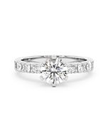 A Blanche-Neige diamond solitaire ring set with a 1.00 carat GIA certified round brilliant cut diamond in white gold, front view, isolated on a white background